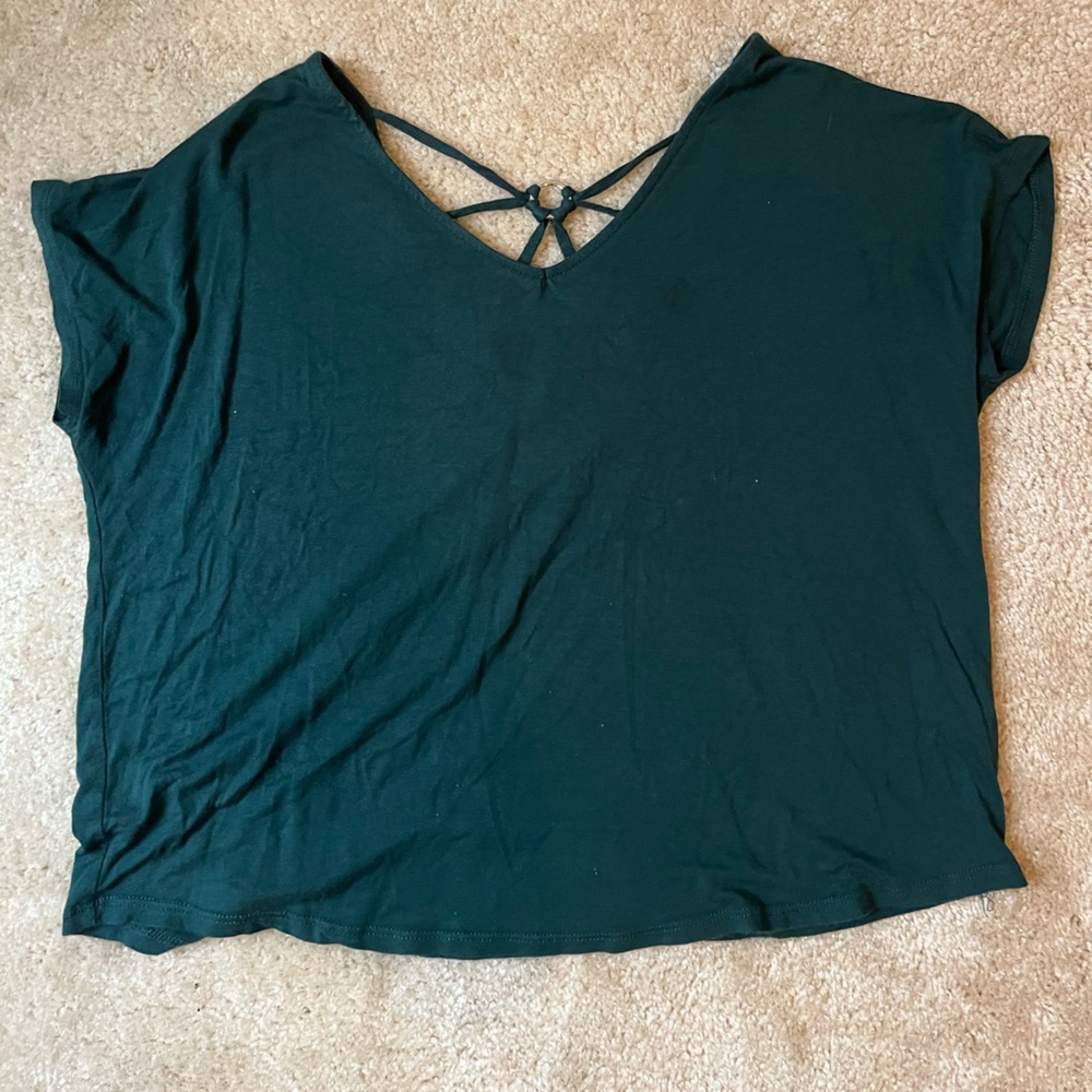 loose dark green blouse with detailing in the back